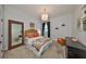 This bedroom is decorated with colorful bedding, a window, and a decorative light fixture at 18423 Lithia Towne Rd, Lithia, FL 33547