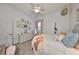 This bedroom is decorated with neutral walls, an eclectic decor, and a ceiling fan at 18423 Lithia Towne Rd, Lithia, FL 33547