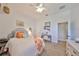 This bedroom features neutral walls, an eclectic decor, and a ceiling fan at 18423 Lithia Towne Rd, Lithia, FL 33547