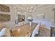 Large dining area with view into the living room featuring neutral tones and ample seating at 18423 Lithia Towne Rd, Lithia, FL 33547