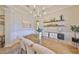Elegant dining room with hardwood floors, decorative shelves, and a wooden table at 18423 Lithia Towne Rd, Lithia, FL 33547
