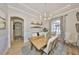 Spacious dining room with hardwood table, elegant seating, and decorative chandelier at 18423 Lithia Towne Rd, Lithia, FL 33547