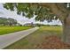 Long driveway winding through a grassy landscape, leading up to a single-story home at 18423 Lithia Towne Rd, Lithia, FL 33547