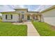 Beautiful home featuring a stone facade, charming fountain, and a pergola with seating at 18423 Lithia Towne Rd, Lithia, FL 33547