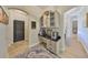 Hallway with custom built-in cabinet and drawer space, black countertop, and overhead lighting at 18423 Lithia Towne Rd, Lithia, FL 33547