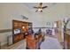 A spacious home office featuring a large desk, custom built-ins, and hardwood floors at 18423 Lithia Towne Rd, Lithia, FL 33547