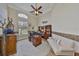 A spacious home office featuring a large desk, custom built-ins, and a comfortable sitting area at 18423 Lithia Towne Rd, Lithia, FL 33547