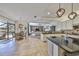 Open-concept kitchen with black countertops and views of the living room and outdoor pool area at 18423 Lithia Towne Rd, Lithia, FL 33547