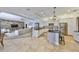 Open kitchen flowing into the living room, featuring stainless steel appliances and a granite island at 18423 Lithia Towne Rd, Lithia, FL 33547