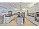 Elegant kitchen with white cabinetry, an island, and stainless steel appliances at 18423 Lithia Towne Rd, Lithia, FL 33547