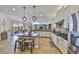 Bright kitchen with a central island, pendant lighting, and stainless steel appliances at 18423 Lithia Towne Rd, Lithia, FL 33547