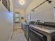 Laundry room featuring modern washer and dryer set, with a window and shelf for storage at 18423 Lithia Towne Rd, Lithia, FL 33547