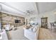 Bright living room featuring a stone accent wall, modern furniture, and tray ceilings at 18423 Lithia Towne Rd, Lithia, FL 33547