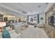 Spacious living room with stone accent wall, tray ceilings, and an open flow to other rooms at 18423 Lithia Towne Rd, Lithia, FL 33547