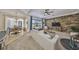 Comfortable living room with a stone accent wall and view of the pool area at 18423 Lithia Towne Rd, Lithia, FL 33547