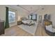 A bright and airy main bedroom with a tray ceiling, hardwood floors, and lots of natural light at 18423 Lithia Towne Rd, Lithia, FL 33547