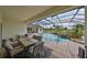 Beautiful patio with furniture, screened in pool, and plenty of space for entertaining at 18423 Lithia Towne Rd, Lithia, FL 33547
