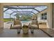 Screened-in pool area with a waterfall, seating, and serene views at 18423 Lithia Towne Rd, Lithia, FL 33547