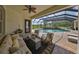 Enclosed pool area featuring outdoor seating, a stone waterfall, and lush landscaping at 18423 Lithia Towne Rd, Lithia, FL 33547