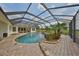 Beautiful screened in pool, landscaped waterfall, and patio seating area for entertaining at 18423 Lithia Towne Rd, Lithia, FL 33547