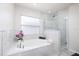 A luxurious bathroom features a separate tub and shower, along with modern fixtures and finishes at 1916 Sandstone Pl, Clearwater, FL 33760