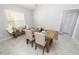 The dining room includes a wooden table, upholstered chairs, bench seating, and tile floors at 1916 Sandstone Pl, Clearwater, FL 33760