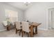 Cozy dining room featuring a wooden table set, bench seating by the window, and neutral colors at 1916 Sandstone Pl, Clearwater, FL 33760