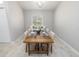 A cozy dining room features a wooden table set for six, with a built-in bench and neutral decor at 1916 Sandstone Pl, Clearwater, FL 33760