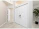 Bright entryway features tile floors, a double front door, and a plant adding a touch of greenery at 1916 Sandstone Pl, Clearwater, FL 33760