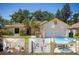 Charming single-story home with a well-manicured lawn, mature trees, and a two-car garage at 1916 Sandstone Pl, Clearwater, FL 33760