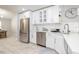 Bright kitchen with stainless steel appliances, white cabinets, and sleek countertops at 1916 Sandstone Pl, Clearwater, FL 33760