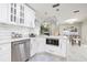 Stylish kitchen with white cabinets, subway tile backsplash, stainless steel appliances, and modern lighting at 1916 Sandstone Pl, Clearwater, FL 33760