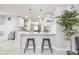 Kitchen area with counter seating, white cabinets, and an open view into other living spaces at 1916 Sandstone Pl, Clearwater, FL 33760