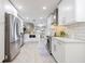 Spacious, updated kitchen with stainless appliances, white cabinetry, and open layout to the dining area at 1916 Sandstone Pl, Clearwater, FL 33760