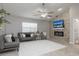 Cozy living room with a fireplace and stone accent wall with recessed lighting at 1916 Sandstone Pl, Clearwater, FL 33760