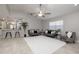 Bright, open living room with tile floors, ceiling fan, and open access to the kitchen at 1916 Sandstone Pl, Clearwater, FL 33760