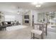 Open-concept living room with a stone fireplace, ceiling fan, and sliding glass doors to the pool at 1916 Sandstone Pl, Clearwater, FL 33760