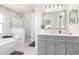 Stylish main bathroom featuring a soaking tub, walk-in shower, and modern vanity at 1916 Sandstone Pl, Clearwater, FL 33760