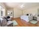 Spacious bedroom features hardwood floors, ceiling fan, sitting area, and an ensuite bath at 1916 Sandstone Pl, Clearwater, FL 33760