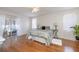 Bright main bedroom with hardwood floors, ceiling fan, and sliding glass door leading to outdoor area at 1916 Sandstone Pl, Clearwater, FL 33760