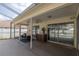 Covered patio offers an inviting outdoor space with seating and views of the pool at 1916 Sandstone Pl, Clearwater, FL 33760