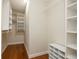 Walk-in closet with wood floors and built-in shelving at 1916 Sandstone Pl, Clearwater, FL 33760
