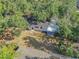 An aerial view capturing the home's backyard layout and its integration with lush greenery at 2003 E Clinton St, Tampa, FL 33610