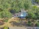 Aerial view of home showcasing the spacious backyard, roof, and surrounding trees at 2003 E Clinton St, Tampa, FL 33610