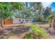 Spacious backyard with mature trees and greenery offering privacy and shade at 2003 E Clinton St, Tampa, FL 33610