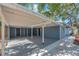 Spacious carport with direct home access, painted beams, and a concrete floor at 2003 E Clinton St, Tampa, FL 33610