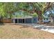 Single story home with long driveway, carport, mature trees, and manicured front lawn at 2003 E Clinton St, Tampa, FL 33610
