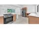 Bright kitchen with stainless steel appliances, modern cabinets, and a view of the front yard at 2003 E Clinton St, Tampa, FL 33610