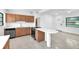 Updated kitchen with stone countertops, wood cabinetry, stainless appliances, and peninsula seating at 2003 E Clinton St, Tampa, FL 33610