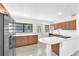 Modern kitchen with quartz counters, stainless steel appliances, and wood cabinetry at 2003 E Clinton St, Tampa, FL 33610